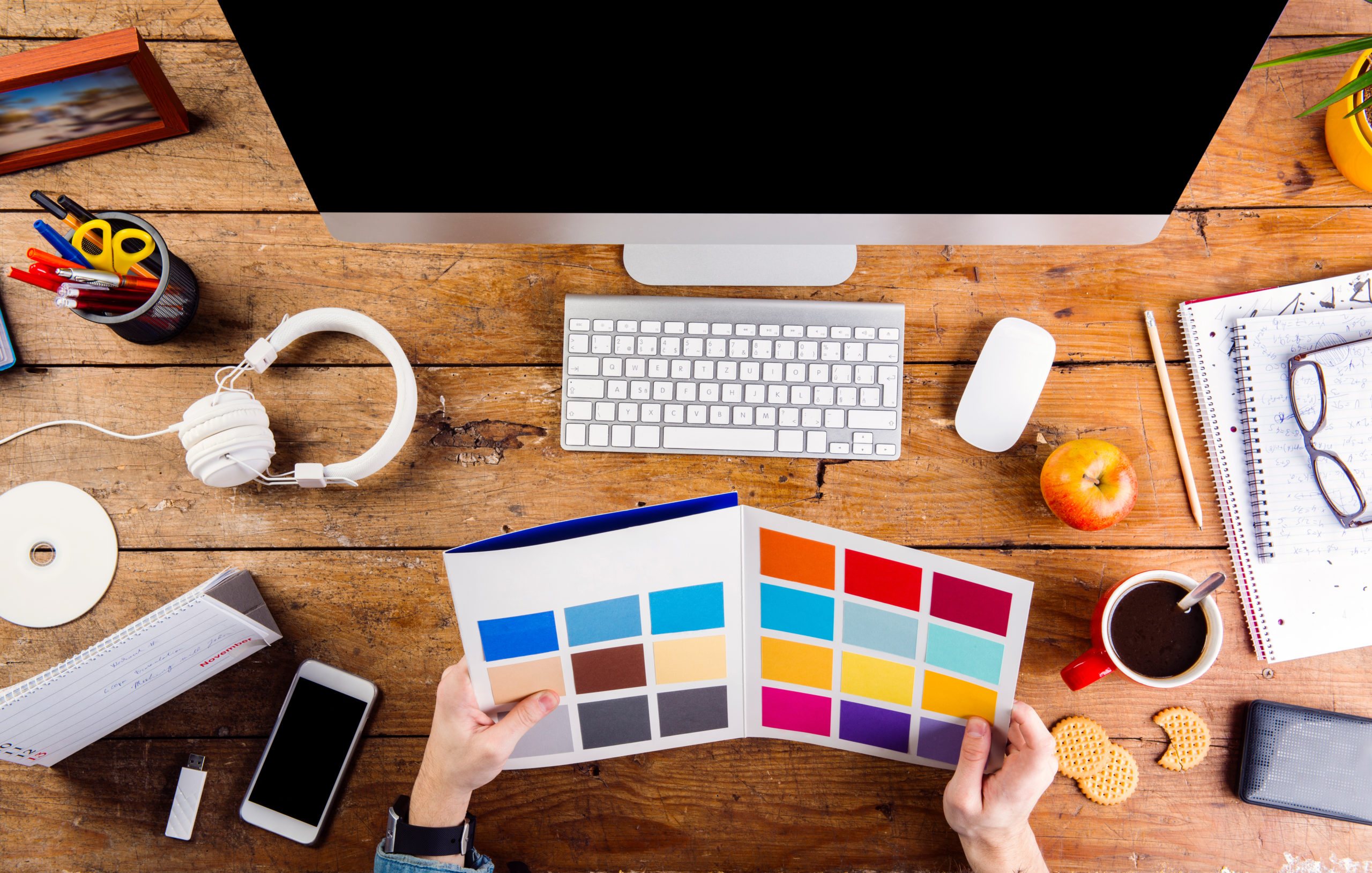 Designer at office desk working with color swatches for business branding